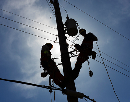 2 electrical engineers working on the lines